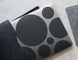Black circular patterned mat on a textured surface