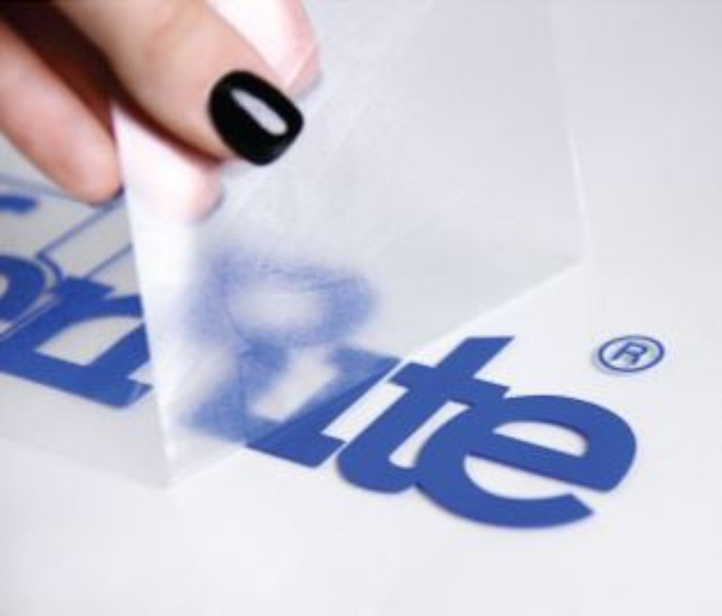 Hand holding a white strip with 'Biltite' branding against a branded background