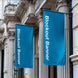 Two blue blockout banners hanging from a building facade.