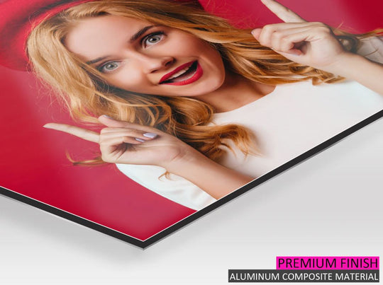 Aluminum composite material panel with a woman pointing, on a white surface.