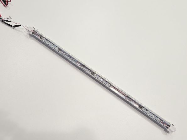 Long rectangular object with connectors on a light gray background