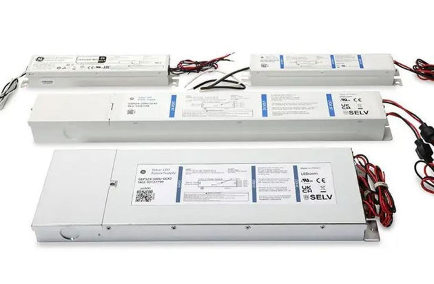 Three LED light bars with wiring on a white background