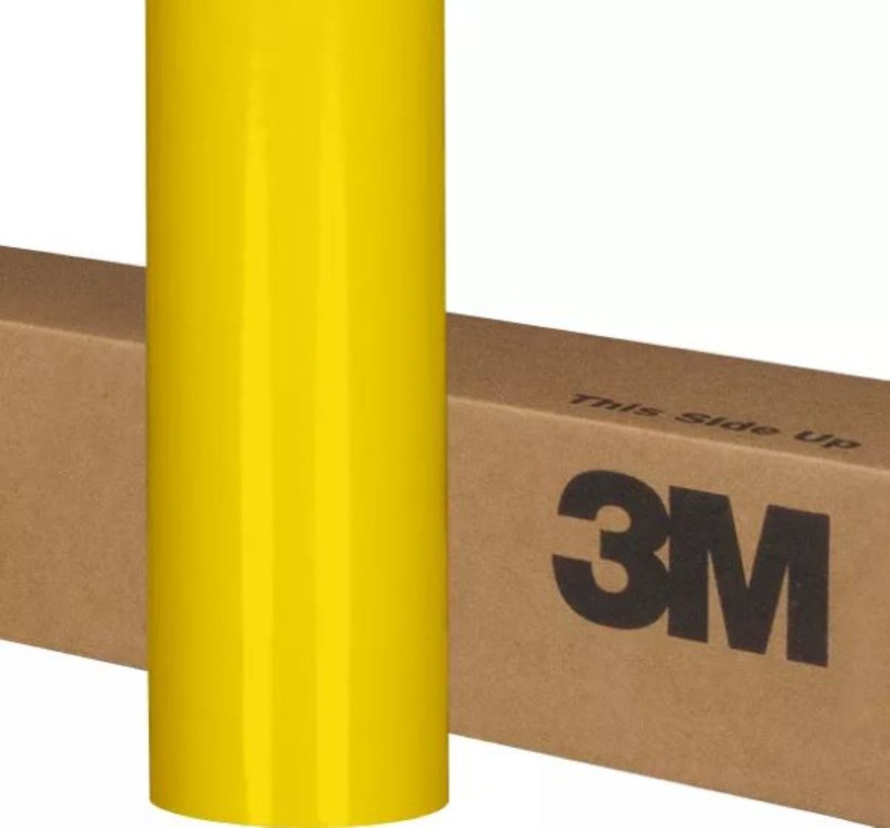 Yellow roll of 3M vinyl wrap on a cardboard box with 'This side up' text.