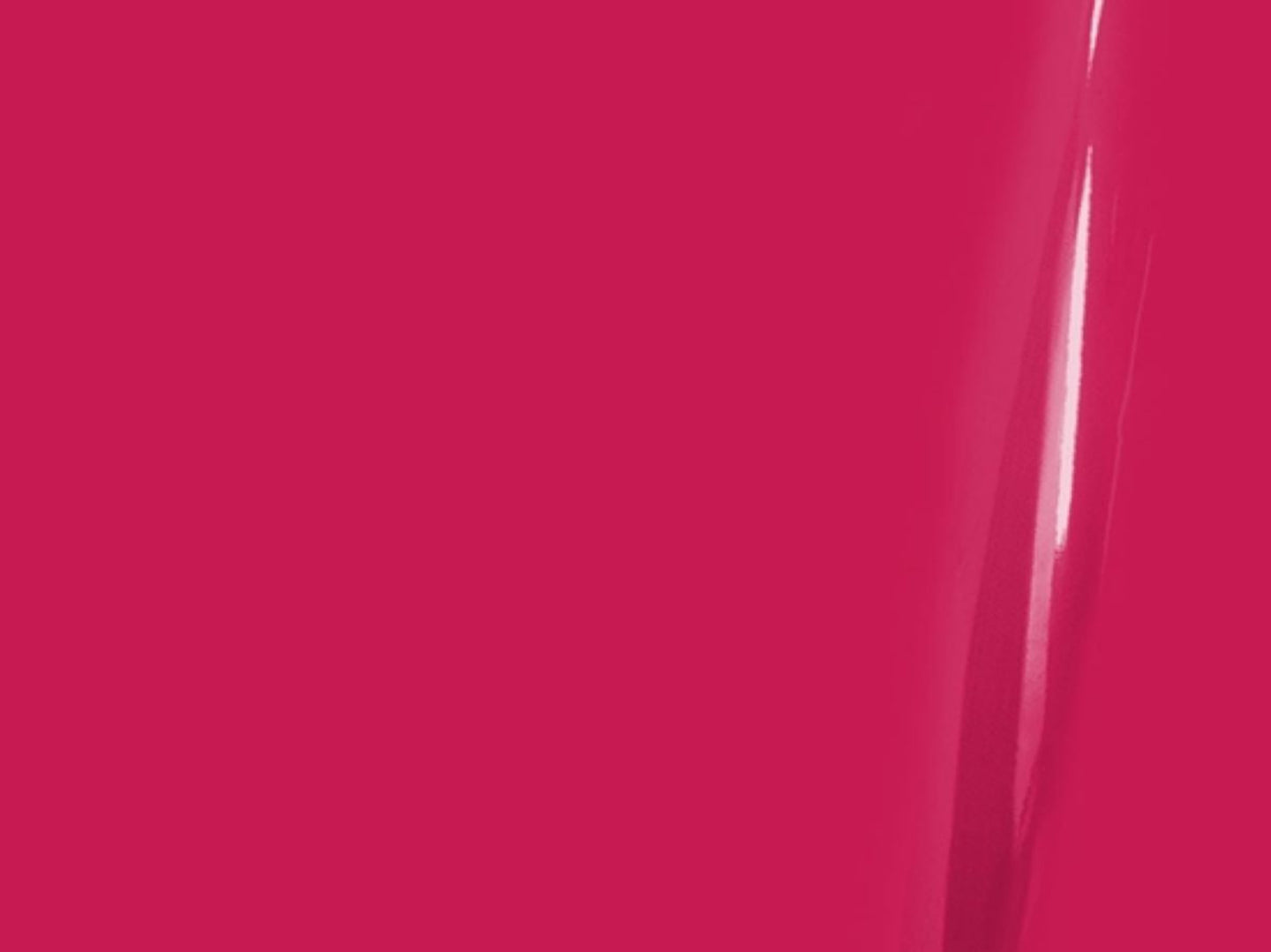 Close-up of a bright pink surface with a subtle reflection.