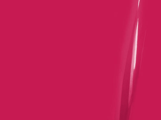 Close-up of a bright pink surface with a subtle reflection.