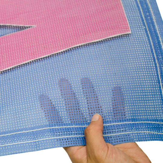 Hand holding a piece of blue and pink woven fabric