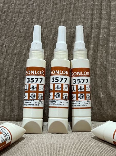 Three Sonlok 3577 spray bottles on a textured surface