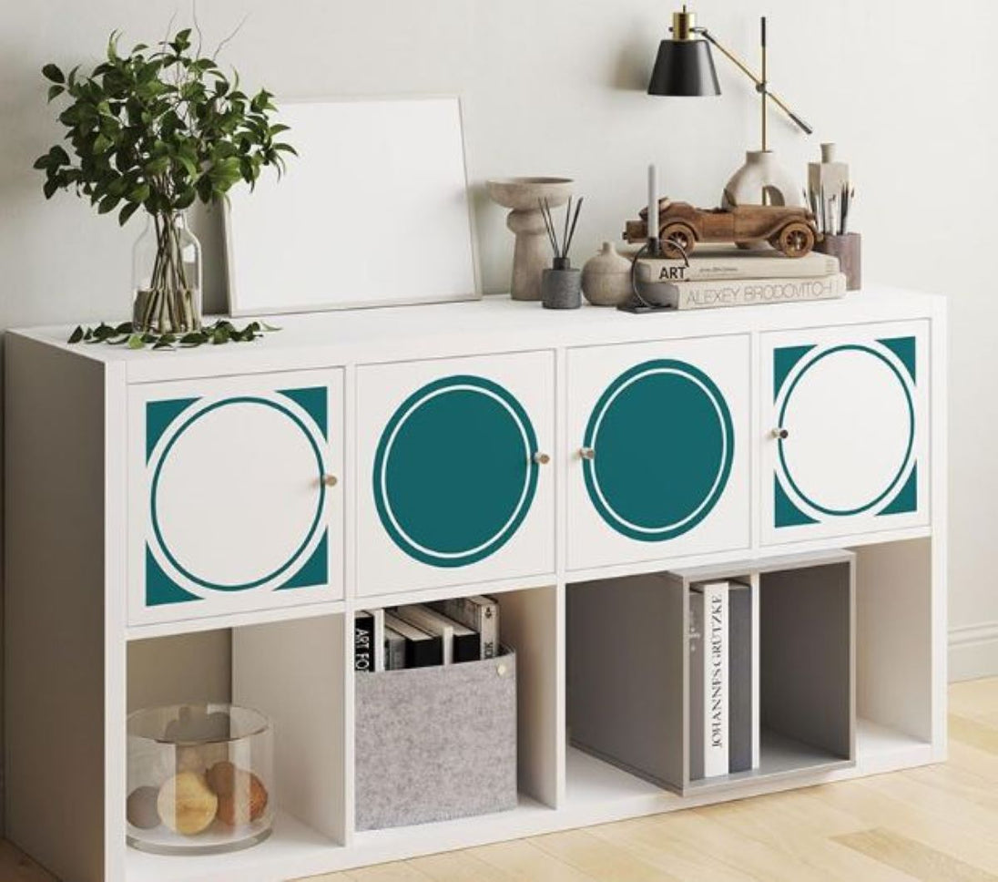 White storage unit with teal circular designs in a room setting.