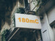 Building facade with a sign displaying '180mC'