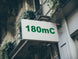 Building facade with a sign displaying '180mC'