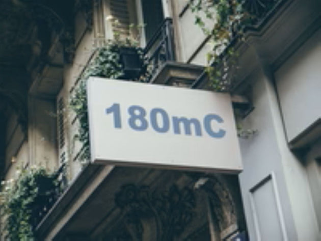 Building facade with a sign displaying '180mC'