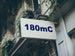 Building facade with a sign displaying '180mC'