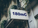 Building facade with a sign displaying '180mC'