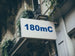 Building facade with a sign displaying '180mC'.