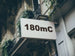 Building facade with a sign displaying '180mC'