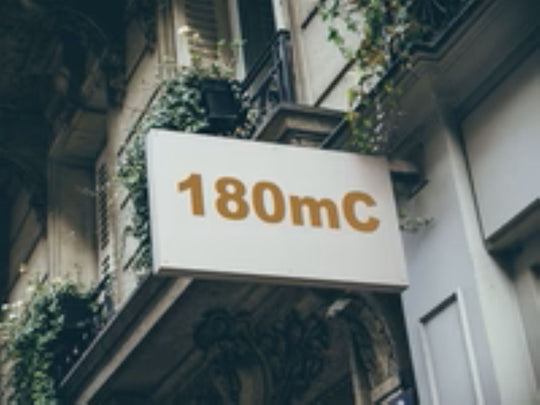 Building facade with a sign displaying '180mC'