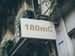 Building facade with a sign displaying '180mC'
