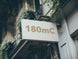Building facade with a sign displaying '180mC'