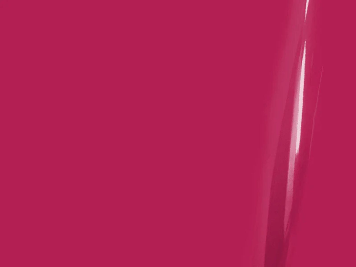 Close-up of a bright pink surface with a glossy finish