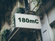 Building facade with a sign displaying '180mC'