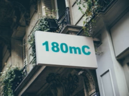 Building facade with a sign displaying '180mC'