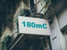 Building facade with a sign displaying '180mC'