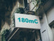 Building facade with a sign displaying '180mC'