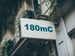 Building facade with a sign displaying '180mC'.