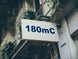 Building facade with a sign displaying '180mC'