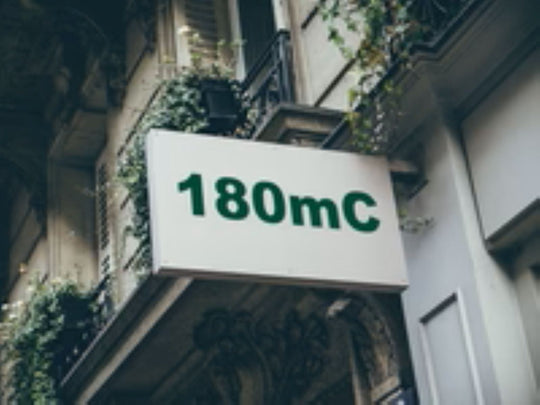 Building facade with a sign displaying '180mC'