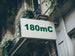 Building facade with a sign displaying '180mC'