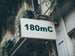Building facade with a sign displaying '180mC'