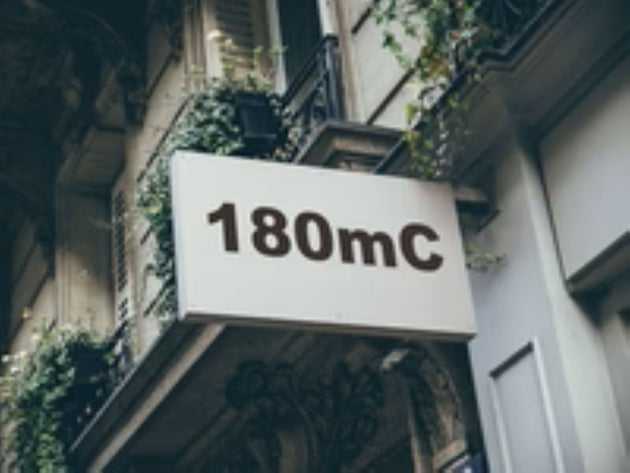 Building facade with a sign displaying '180mC'
