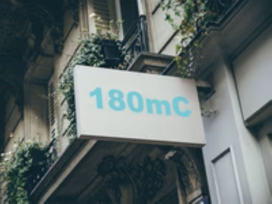 Building facade with a sign displaying '180mC'