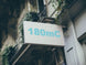 Building facade with a sign displaying '180mC'