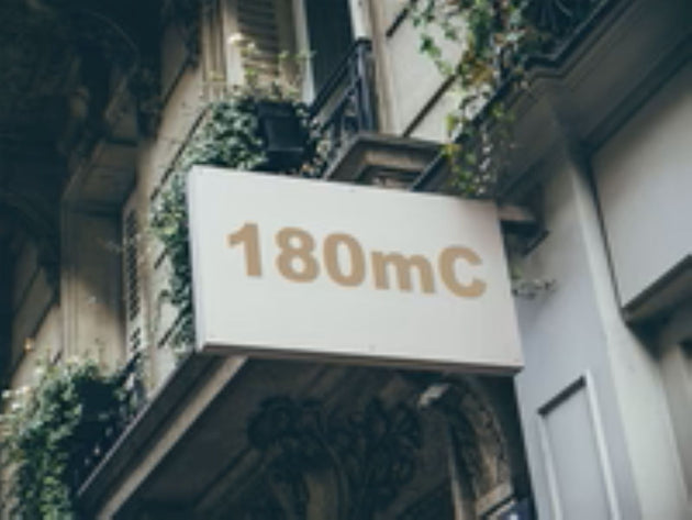 Building facade with a sign displaying '180mC'
