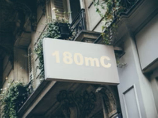 Building facade with a sign displaying '180mC'