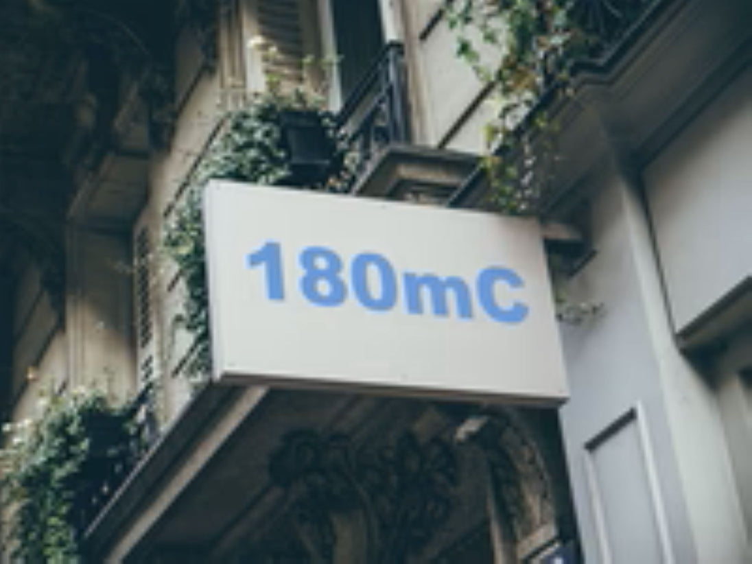 Building facade with a sign displaying '180mC'
