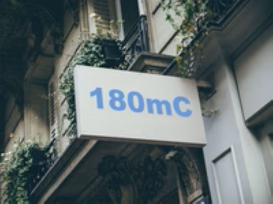 Building facade with a sign displaying '180mC'