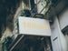 Building facade with a sign displaying '180mC' in gold lettering.