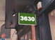 Green sign with the number 3630 on a building exterior