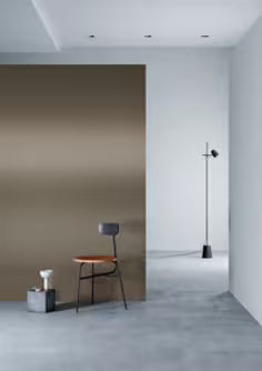 Modern interior with a chair against a beige wall and a white wall.