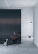 Modern interior with a black mirror leaning against a white wall.