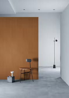 Modern interior with a brown wall, gray floor, and minimal furniture.
