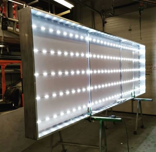 Large LED display panel in a workshop setting