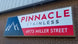 Pinnacle Stainless sign on a brick building