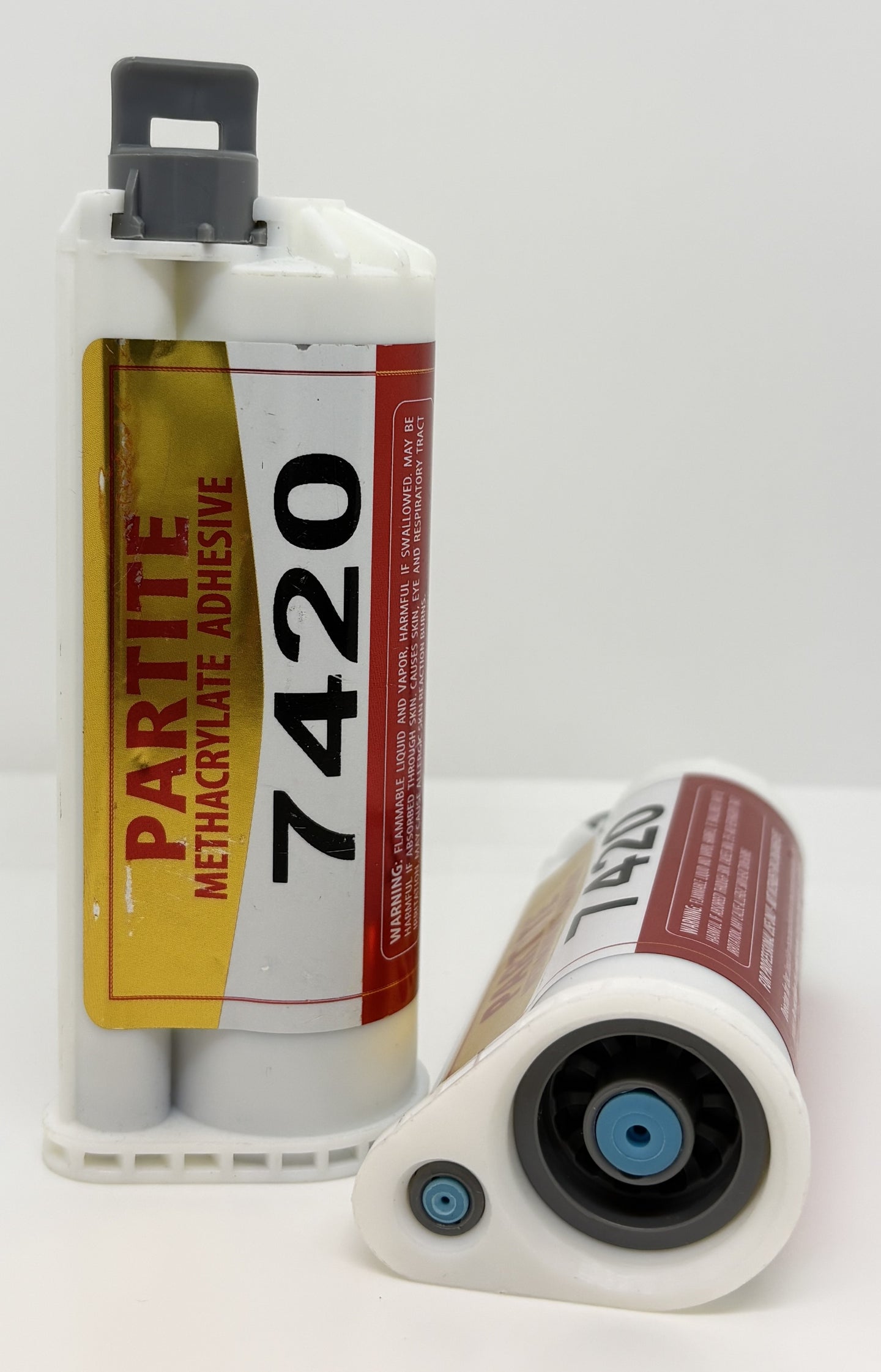 Two bottles of Partite Methacrylate Adhesive 7420 on a white background