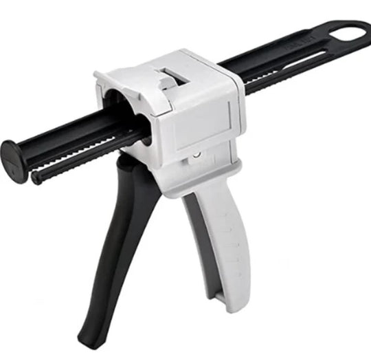 White and black caulking gun on a white background