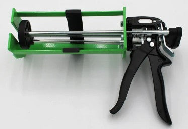 Caulking gun with green handle and black nozzle on a white background