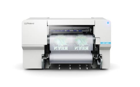 Roller printing machine with 'Roland' branding on a white background
